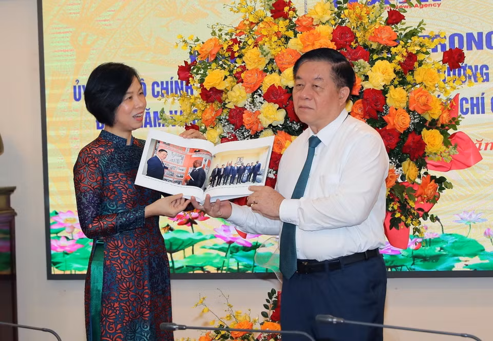 Tổng Giám đốc TTXVN Vũ Việt Trang tặng cuốn sách ảnh cho Trưởng Ban Tuyên giáo Trung ương Nguyễn Trọng Nghĩa. (Ảnh: Trọng Đức/TTXVN)