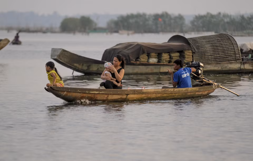 Một gia đình ngư dân trở về sau một đêm đánh bắt thủy sản trên đầm phá. (Ảnh: Hồ Cầu/TTXVN)