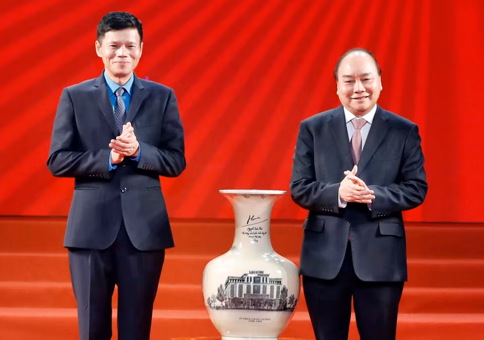Thủ tướng Nguyễn Xuân Phúc tặng quà lưu niệm cho Báo Lao động. (Ảnh: Thống Nhất/TTXVN)