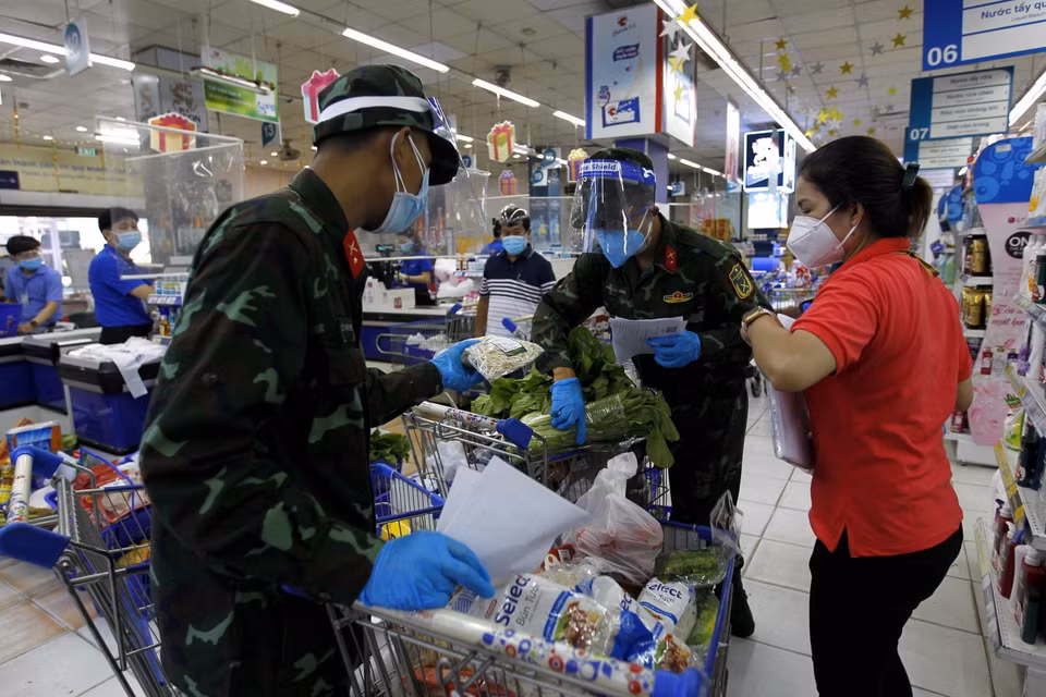 Nhiều chiến sỹ nhờ trợ giúp thông tin, hàng hóa từ các nhân viên siêu thị để đi chợ giúp dân đúng và đầy đủ theo nhu cầu. (Ảnh: Thanh Vũ/TTXVN)