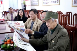 Người dân phường Hòa Bình (Phú Thọ) nghiên cứu thông tin Đại hội đại biểu toàn quốc lần thứ XIV của Đảng qua kênh báo chí. (Ảnh: Thanh Hải/TTXVN)