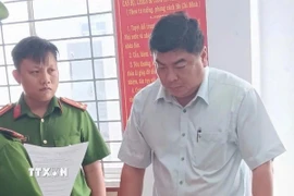 Ông Nguyễn Bảo Sinh, nguyên Phó Chủ tịch Ủy ban Nhân dân thành phố Long Xuyên, tỉnh An Giang, nghe các quyết định khởi tố, bắt giam. (Ảnh: TTXVN phát)