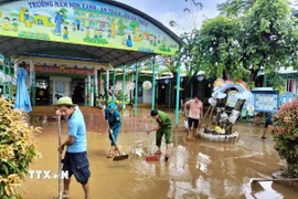 Lực lượng vũ trang thành phố Đà Nẵng giúp cơ sở giáo dục dọn vệ sinh sau mưa lũ. (Ảnh: Trần Tĩnh/TTXVN)