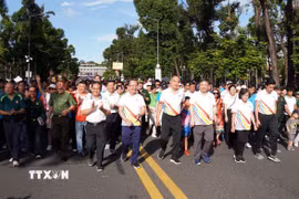 Lãnh đạo Thành phố Hồ Chí Minh cùng đại biểu, cán bộ, chiến sỹ, đoàn viên, thanh niên và người dân tham gia Chương trình đi bộ đồng hành kỷ niệm 50 năm Ngày Thành phố Sài Gòn-Gia Định chính thức vinh dự mang tên Chủ tịch Hồ Chí Minh. (Ảnh: Trung Tuyến/TTXVN)