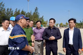 Chủ tịch Ủy ban Nhân dân tỉnh Quảng Ngãi Nguyễn Hoàng Giang (thứ 2, từ phải sang) nghe đại diện đội cứu hộ, cứu nạn báo cáo quá trình tìm kiếm nạn nhân Trần Ngọc Tr. bị đuối nước mất tích. (Ảnh: Lê Phước Ngọc/TTXVN)