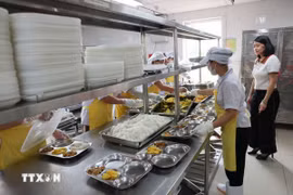 Chuẩn bị bữa ăn bán trú cho học sinh. (Ảnh: Thanh Tùng/TTXVN)