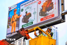 Đơn vị thi công hoàn thiện những hạng mục cuối cùng của hệ thống bảng thông tin giao thông điện tử trên địa bàn Hà Nội. (Ảnh: Trung Nguyên/TTXVN)
