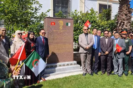 Cán bộ Đại sứ quán Việt Nam và bạn bè Algeria chụp ảnh lưu niệm bên cạnh Bia tưởng niệm Bác. (Ảnh: Mạnh Hùng/TTXVN)
