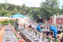 Các lực lượng chức năng tổ chức lấy mẫu ADN tại Nghĩa trang liệt sỹ Đăk Đoa, tỉnh Gia Lai. (Ảnh: Quang Thái/TTXVN)