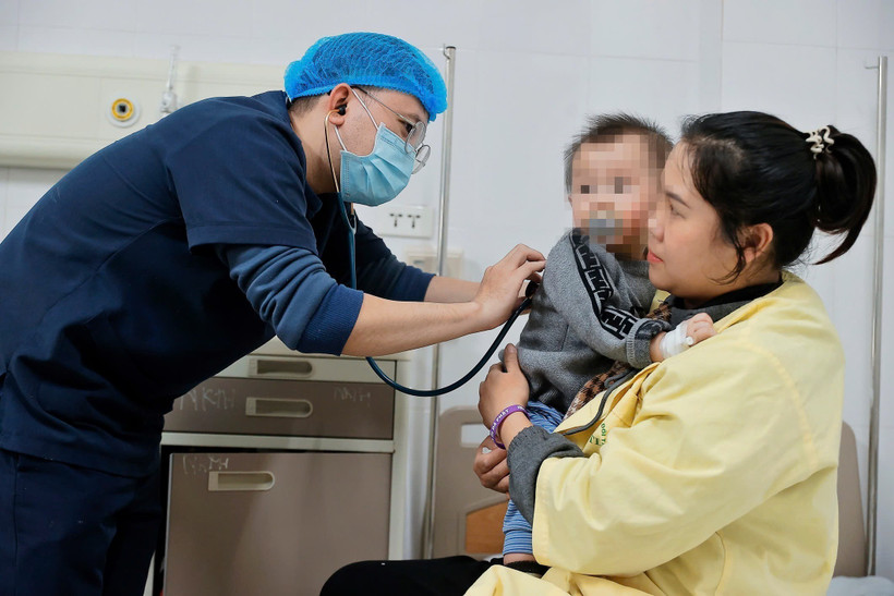 Bác sỹ thăm khám cho bệnh nhi mắc cúm A đang điều trị tại Khoa Nhi, Bệnh viện Bệnh nhiệt đới Trung ương. (Ảnh: Minh Quyết/TTXVN)