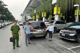Dựng lại hiện trường hai đối tượng “cò mồi” lừa đảo nam hành khách quốc tế tại Sân bay Nội Bài. (Ảnh: PV/Vietnam+)