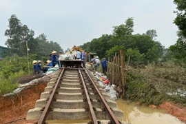Ngành đường sắt đang nỗ lực ngày, đêm khắc phục vị trí xói lở nền đường do nước lũ tuyến đường sắt Đông Anh-Quán Triều. (Ảnh: PV/Vietnam+)