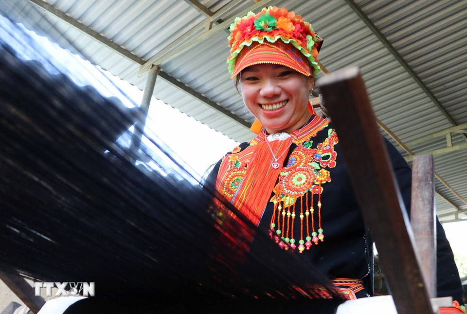 Phụ nữ Dao vui mừng khi hoàn thành những cuộn sợi đẹp để may trang phục. (Ảnh: Nguyễn Oanh/TTXVN)
