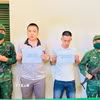Hai đối tượng Lê Phúc và Trương Quang Hào bị bắt với hành vi “tổ chức cho người khác xuất cảnh Việt Nam trái phép." (Ảnh: TTXVN phát)