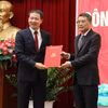 Trưởng Ban Tổ chức Trung ương Lê Minh Hưng (bên phải) trao quyết định của Bộ Chính trị về việc điều động, chỉ định ông Vũ Hồng Văn giữ chức Bí thư Tỉnh ủy Đồng Nai. (Ảnh: Công Phong/TTXVN)