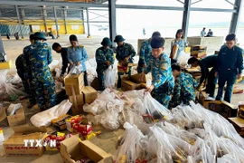 Lương thực, thực phẩm, nhu yếu phẩm được sắp xếp lên máy bay để chuyển đến người dân vùng lũ. (Ảnh: Trần Lê Lâm/TTXVN)