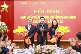 Bí thư Tỉnh ủy Bắc Giang Nguyễn Văn Gấu tặng hoa chúc mừng Phó Bí thư Thường trực Tỉnh uỷ Nguyễn Thị Hương (phải) và Phó Bí thư Tỉnh ủy Nguyễn Việt Oanh (trái). (Ảnh: TTXVN phát)