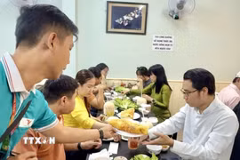 Du khách thưởng thức ẩm thực địa phương đặc trưng trong tour du lịch Thành phố Hồ Chí Minh. (Ảnh: Mỹ Phương/TTXVN)