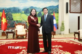 Tổng Bí thư, Chủ tịch nước Lào Thongloun Sisoulith (phải) tiếp Phó Chủ tịch nước Việt Nam Võ Thị Ánh Xuân sang thăm chính thức Lào. (Ảnh: Xuân Tú/TTXVN)