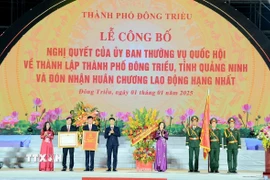 Phó Chủ tịch Quốc hội Nguyễn Thị Thanh trao Nghị quyết của Ủy ban Thường vụ Quốc hội về thành lập thành phố và Huân chương Lao động hạng Nhất cho Đảng bộ, chính quyền, nhân dân thành phố Đông Triều. (Ảnh: Thanh Vân/TTXVN)