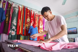 Các nghệ nhân nơi đây vẫn giữ được những kỹ thuật truyền thống cùng với sự khéo léo và kỹ thuật trong từng đường kim, mũi chỉ tạo nên sự khác biệt cho Nghề may Trạch Xá. (Ảnh: Khánh Hòa/TTXVN)