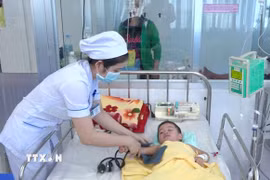 Bác sỹ Bệnh viện sản nhi An Giang điều trị cho trẻ mắc bệnh sốt xuất huyết. (Ảnh: Thanh Sang/TTXVN)
