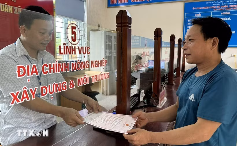 Người dân làm thủ tục hành chính tại bộ phận một cửa xã Phúc Thịnh, huyện Ngọc Lặc phấn khởi nhận kết quả. (Ảnh: TTXVN phát)