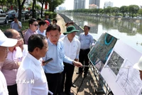 Chủ tịch UBND Thành phố Hồ Chí Minh Nguyễn Văn Được nghe chủ đầu tư báo cáo tình hình triển khai dự án. (Ảnh: Tiến Lực/TTXVN)