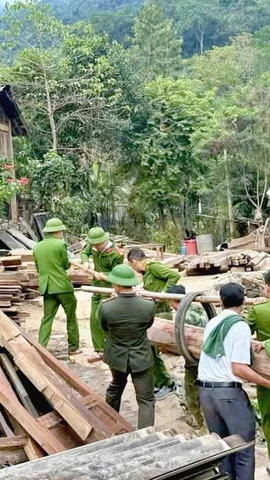 Các lực lượng giúp người dân bản Vàng Phao tháo dỡ nhà cửa để di dời đến khu tái định cư. (Nguồn: báo Nghệ An)