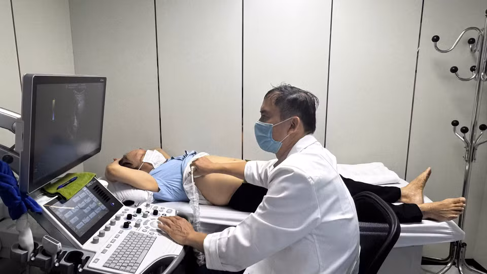 Bác sỹ siêu âm tổng quát cho người dân đến khám. (Ảnh: PV/Vietnam+)