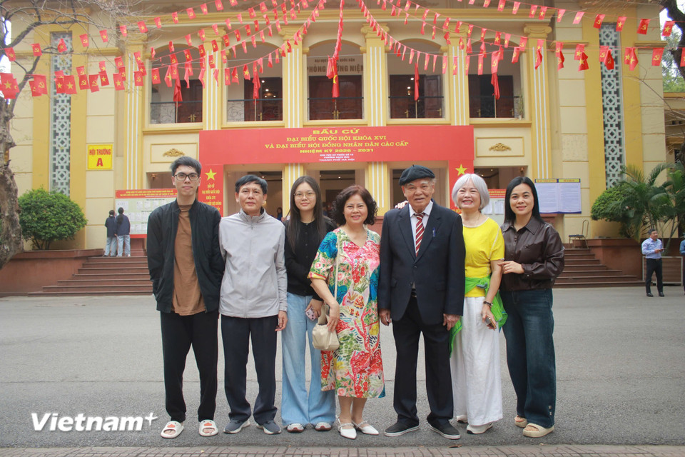 Cụ ông Nguyễn Đức Khiết (94 tuổi) cùng con cháu trong gia đình đến điểm bỏ phiếu số 15 phường Bạch Mai. (Ảnh: Minh Anh/Vietnam+)