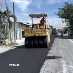 Tranh thủ thời tiết khô ráo, nhà thầu triển khai thảm nhựa Quốc lộ 30, đoạn qua ấp Gò Da, xã Tân Hồng. (Ảnh: Nhựt An/TTXVN)