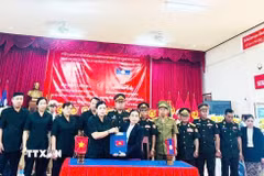 Đồng chí Y Ngọc (trái), Phó Chủ tịch Thường trực Ủy ban Nhân dân tỉnh Quảng Ngãi, Trưởng ban Chỉ đạo công tác đặc biệt tỉnh và đồng chí Sisanga Keoduangdi, Phó Chủ tịch Ủy ban chính quyền tỉnh Xekong, Trưởng ban Công tác đặc biệt tỉnh Xekong trao Biên bản bàn giao tại buổi Lễ. (Ảnh: TTXVN phát)