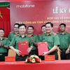 Thiếu tướng Trương Sơn Lâm - Chủ tịch MobiFone và Thiếu tướng Nguyễn Thanh Hải - Giám đốc Công an tỉnh Vĩnh Long trao văn bản hợp tác. (Ảnh: PV/Vietnam+)