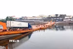 Các phương tiện được thông quan và chở hàng hóa qua lối mở cầu phao Km3+4 Hải Yên. (Ảnh: Vi Thu/TTXVN phát)