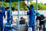 Các lực lượng tổ chức triển khai lấy mẫu, số hóa thông tin và bàn giao mẫu hài cốt liệt sỹ tại Nghĩa trang liệt sỹ Vĩnh Linh (tỉnh Quảng Trị). (Ảnh: TTXVN phát)