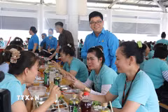 Công nhân dùng “Bữa cơm Công đoàn”. (Ảnh: Thanh Bình/TTXVN)