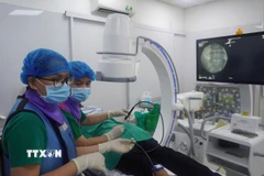 Các bác sỹ đang thực hiện kỹ thuật áp đông thần kinh cho bệnh nhân. (Ảnh: TTXVN phát)