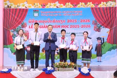 Đại sứ Nguyễn Minh Tâm trao tặng giấy khen cho học sinh đạt thành tích tốt trong kỳ thi học sinh giỏi cấp huyện, cấp thành phố năm học 2025 - 2026. (Ảnh: Xuân Tú/TTXVN)