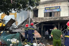 Lực lượng chức năng có mặt kịp thời khống chế ngọn lửa. (Ảnh: Đỗ Trưởng/TTXVN)