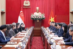 Đại tướng Lương Tam Quang, Bộ trưởng Bộ Công an hội đàm với Bộ trưởng Bộ Phát triển Kỹ thuật số và Thông tin Singapore Josephine Teo. (Ảnh: Phạm Kiên/TTXVN)