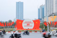 Khẩu hiệu, biểu trưng Đại hội nổi bật giữa dòng xe qua lại trên đường phố Hà Nội. (Ảnh: Lê Đông/TTXVN)