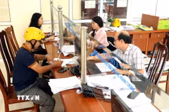 Người dân đến làm thủ tục hành chính tại Bảo hiểm xã hội tỉnh Hưng Yên. (Ảnh: Đinh Văn Nhiều/TTXVN)