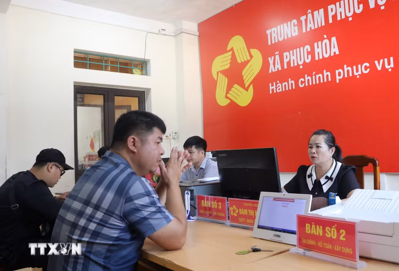 Người dân đến Trung tâm phục vụ hành chính công xã Phục Hòa giải quyết thủ tục hành chính. (Ảnh: Chu Hiệu/TTXVN)