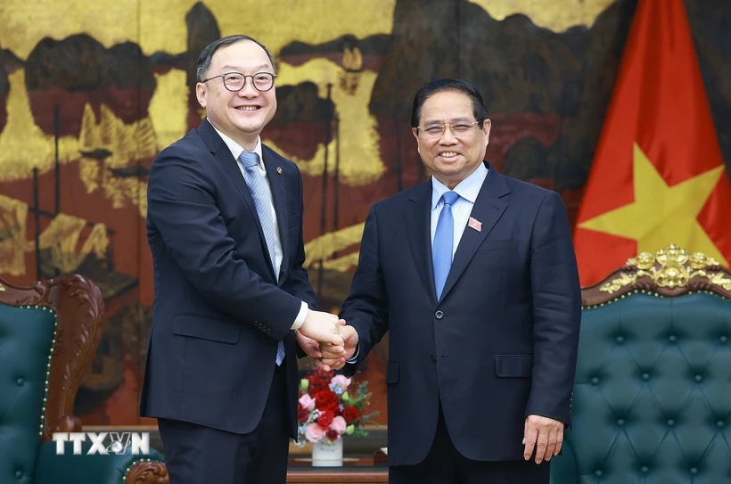 Thủ tướng Phạm Minh Chính tiếp ông Châu Gia Nghĩa, Chủ tịch Khu vực Châu Á-Thái Bình Dương của Tập đoàn Xây dựng Điện lực Trung Quốc. (Ảnh: Dương Giang/TTXVN)