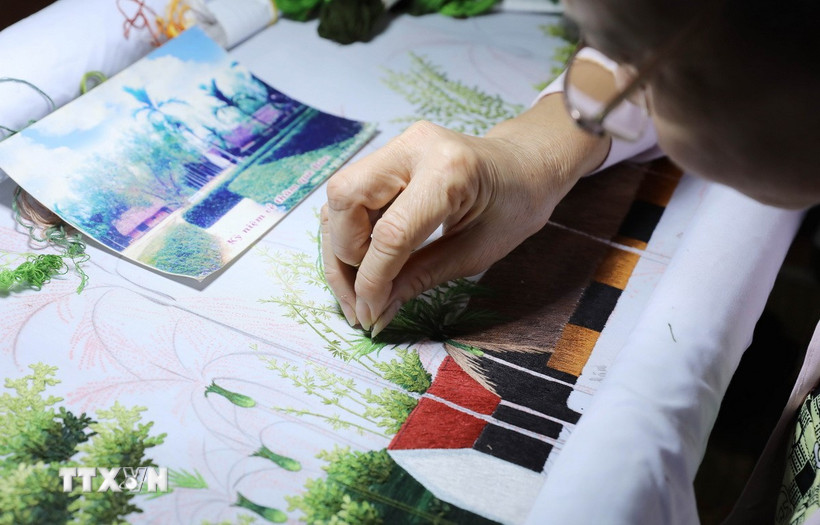 Giữa nhịp sống hối hả, người dân xã Thư Trì, tỉnh Hưng Yên vẫn cần mẫn, miệt mài bên khung thêu, tỉ mỉ từng đường kim mũi chỉ để giữ nghề truyền thống. (Ảnh: Thế Duyệt/TTXVN)
