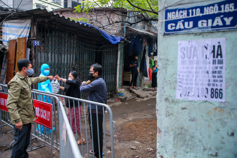 Những người dân trong khu cách ly được tiếp nhận nhu yếu phẩm hàng ngày miễn phí từ chính quyền. (Ảnh: Minh Sơn/Vietnam+)