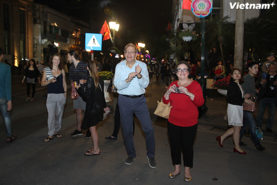 Các bạn Tây cũng hòa nhịp trong thời khắc giao thừa thiêng liêng. (Ảnh: Thành Nguyễn/Vietnam+)