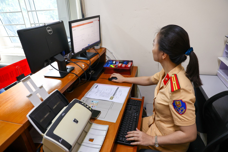 Trong ngày đầu ôtô, xe máy được quản lý theo mã định danh, lực lượng chức năng đã chuẩn bị phần mềm đăng ký xe cùng hàng ngàn bộ hồ sơ gốc để nhanh chóng tích hợp biển số xe vào mã số định danh. (Ảnh: Minh Sơn/Vietnam+)