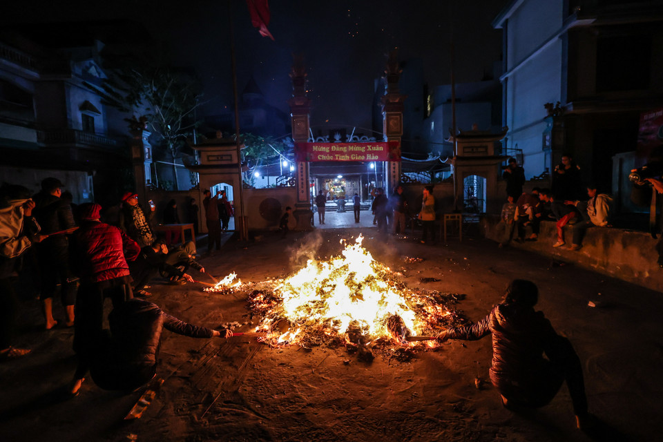 Cũng có quan niệm cho rằng lấy được càng nhiều lửa, trong năm sẽ càng may mắn, lộc lá nhiều. Do đó, nhiều người chạy đi chạy lại 'xin đỏ' nhiều lần. (Ảnh: Minh Sơn/Vietnam+)